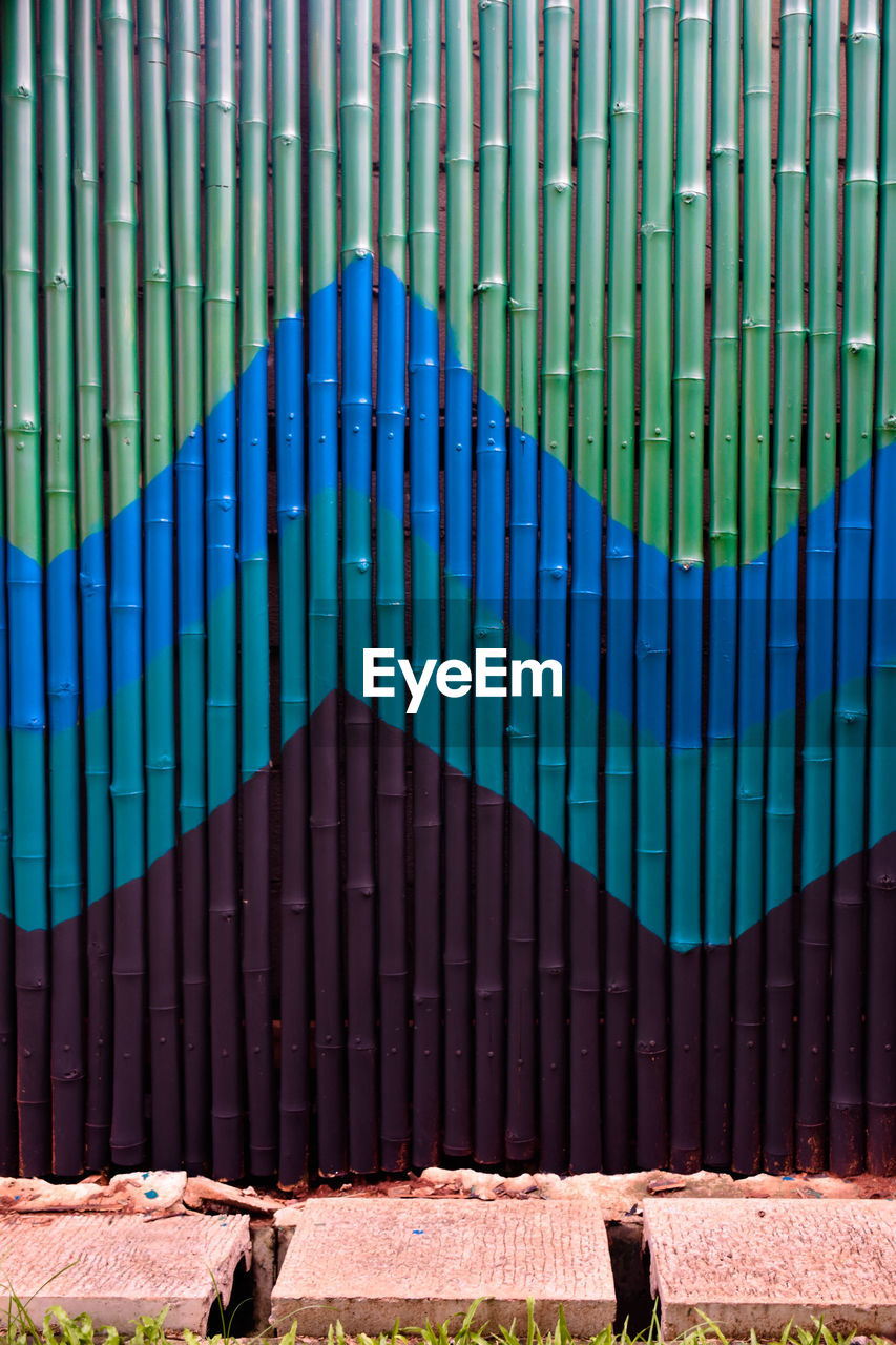 Metal gate against blue wall