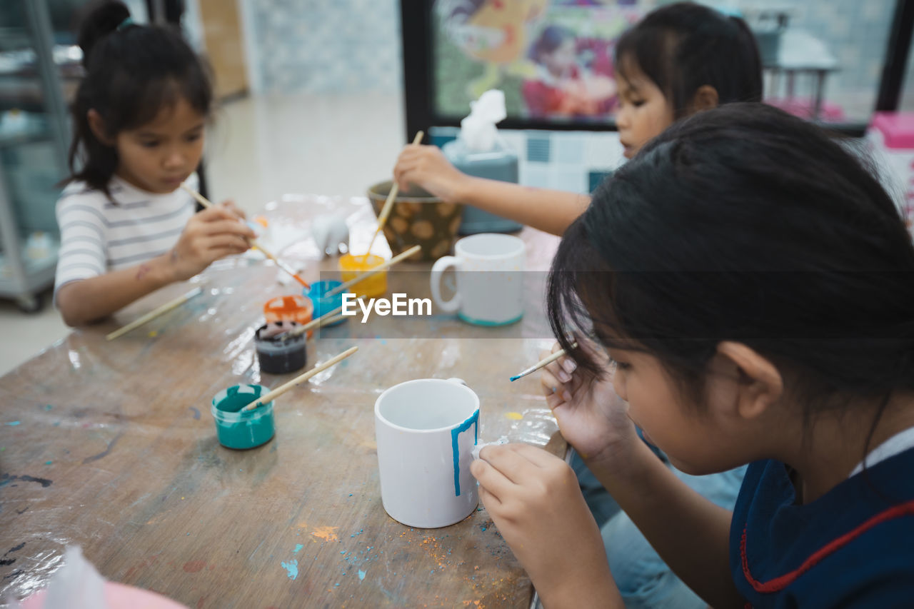 High angle view of people making decoration on table