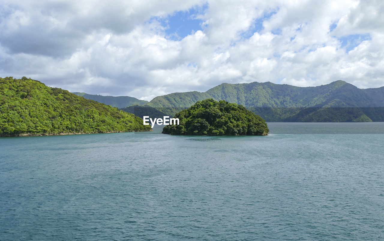 SCENIC VIEW OF SEA AND MOUNTAIN AGAINST SKY