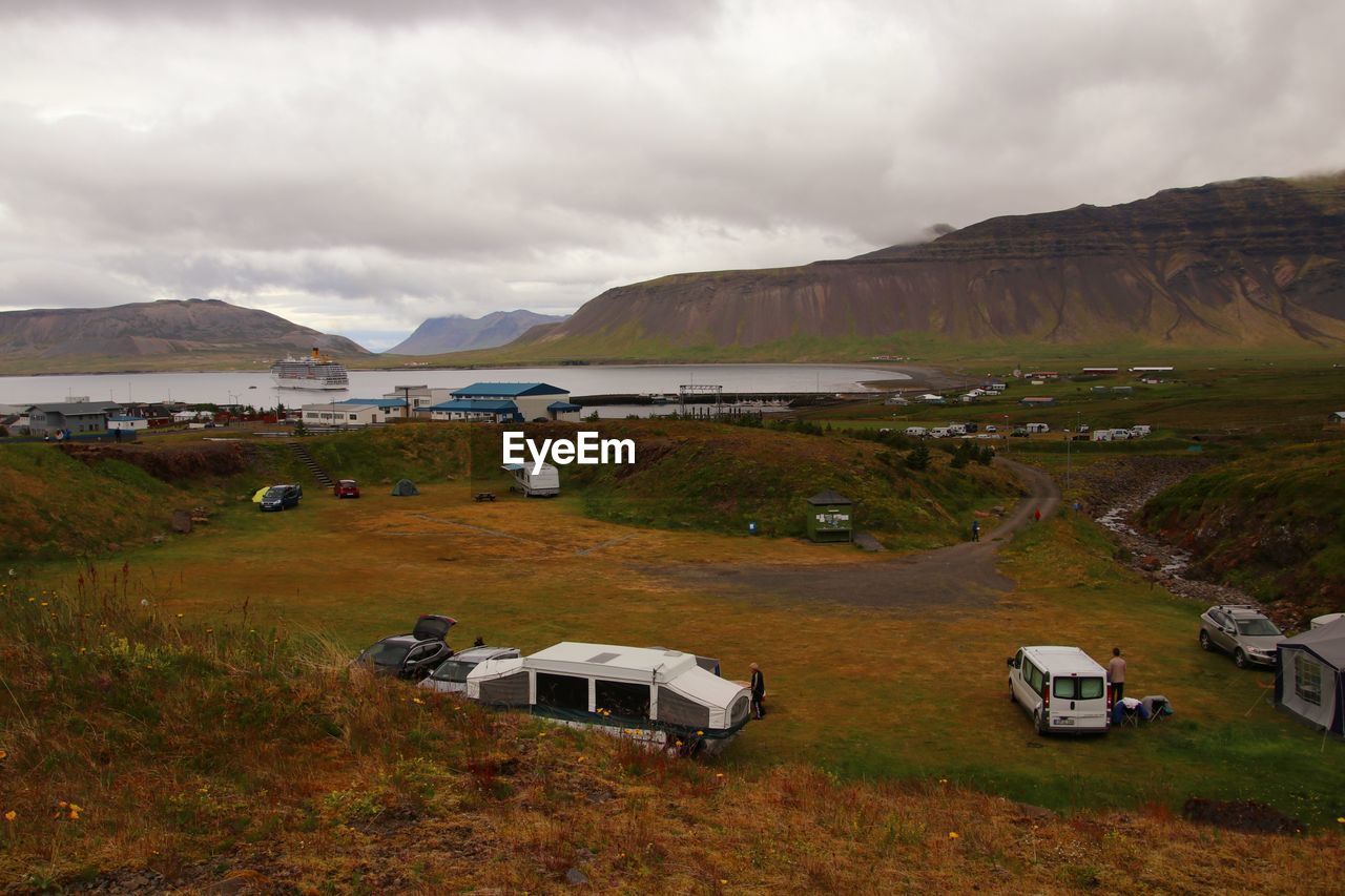 Scenic view of land and mountains against sky