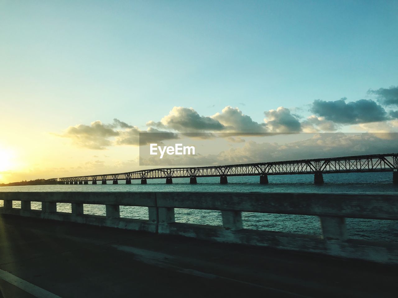 BRIDGE OVER WATER AGAINST SKY