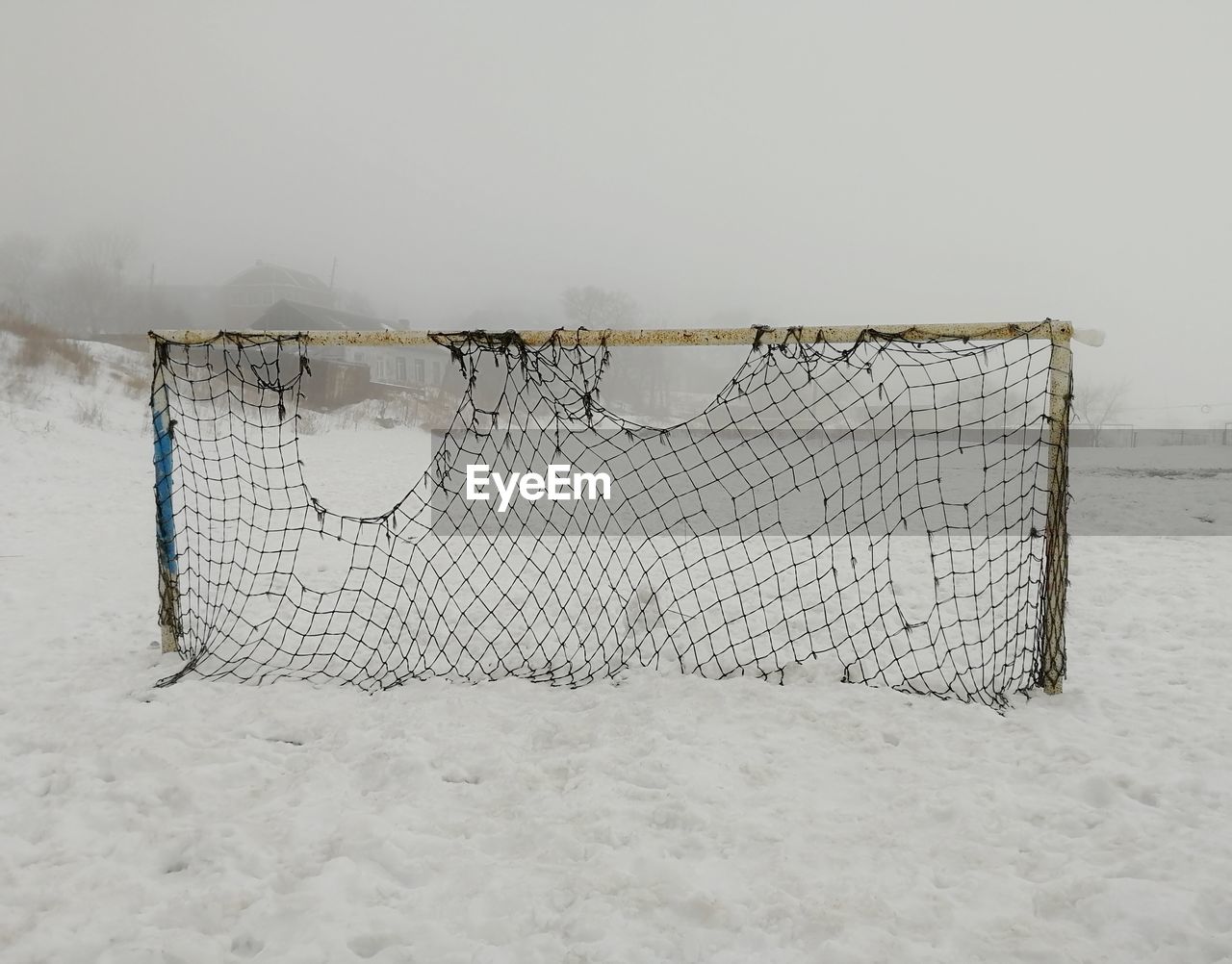 Football gate on a background of a foggy landscape during winter 