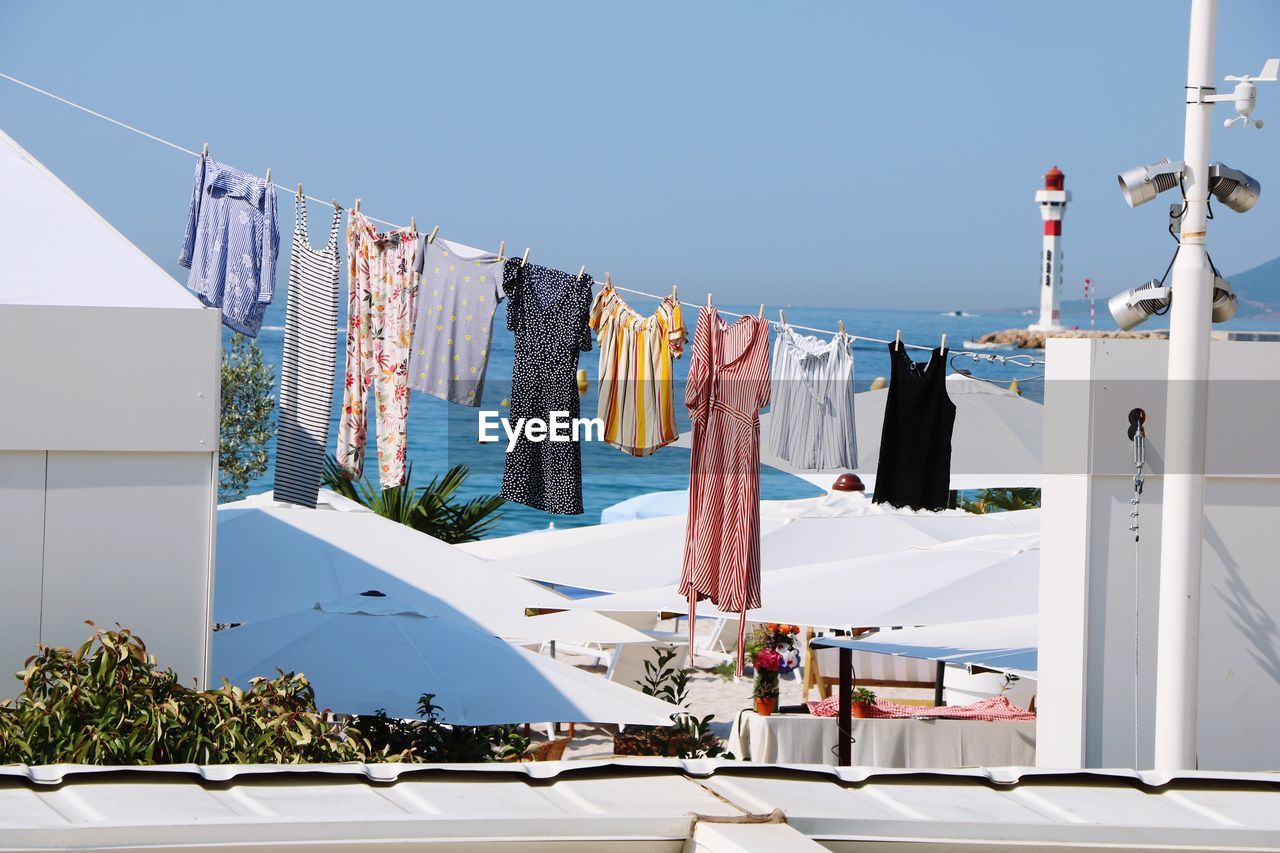 Clothes drying on clothesline against sea