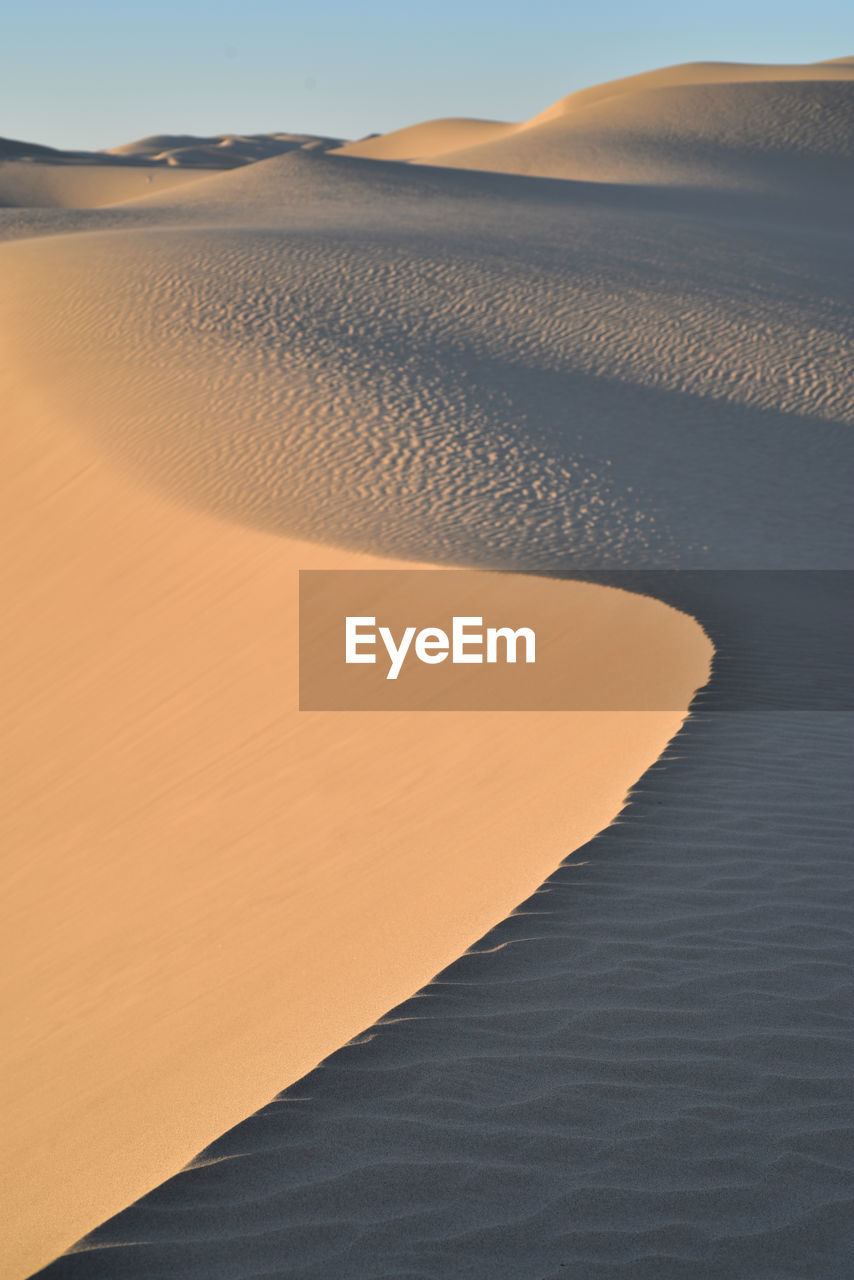 Scenic view of desert against sky during sunset