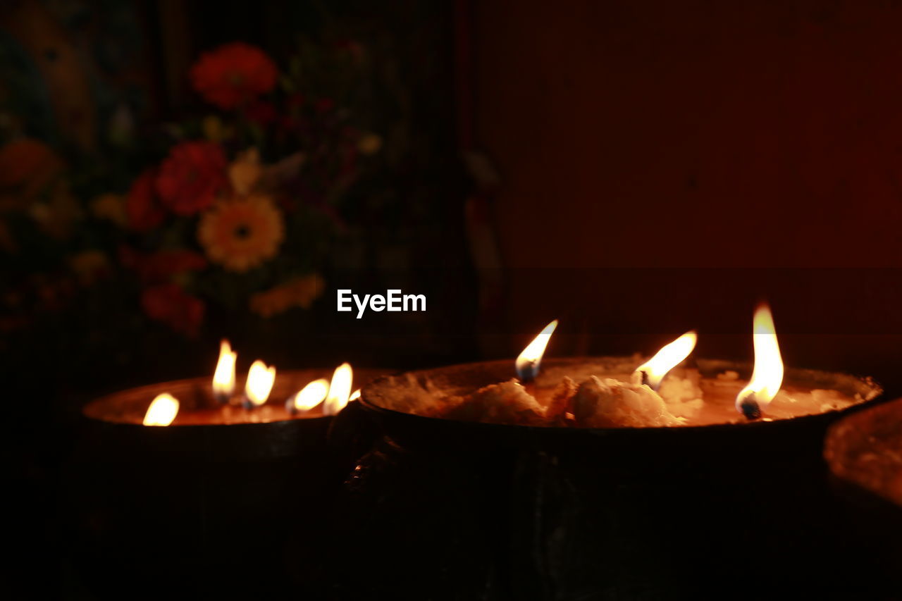 CLOSE-UP OF LIT CANDLES BURNING