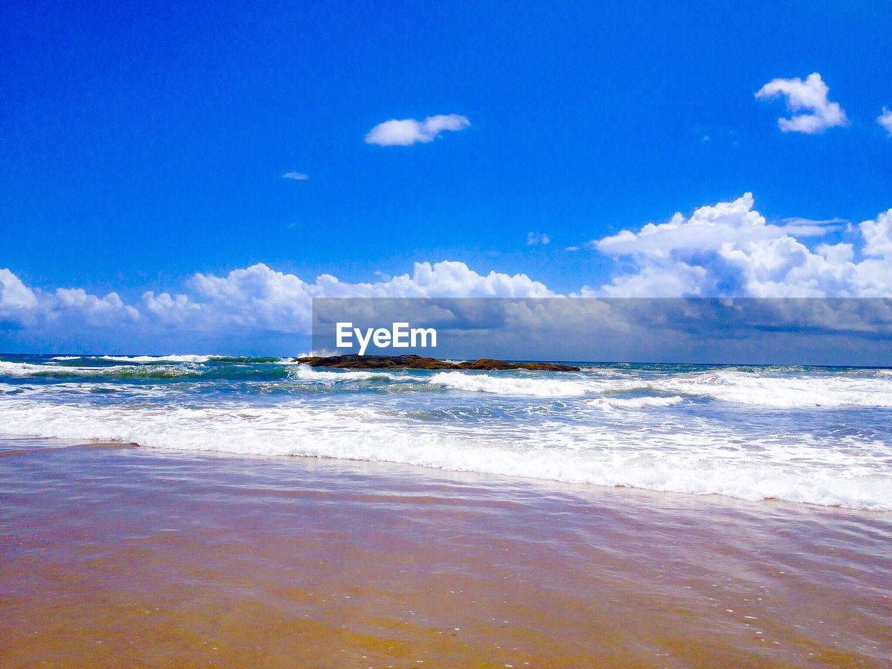 Scenic view of sea against blue sky