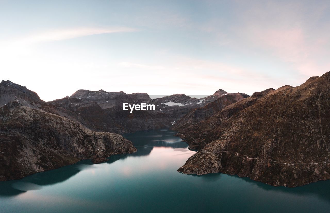 Scenic view of lake and mountains against sky