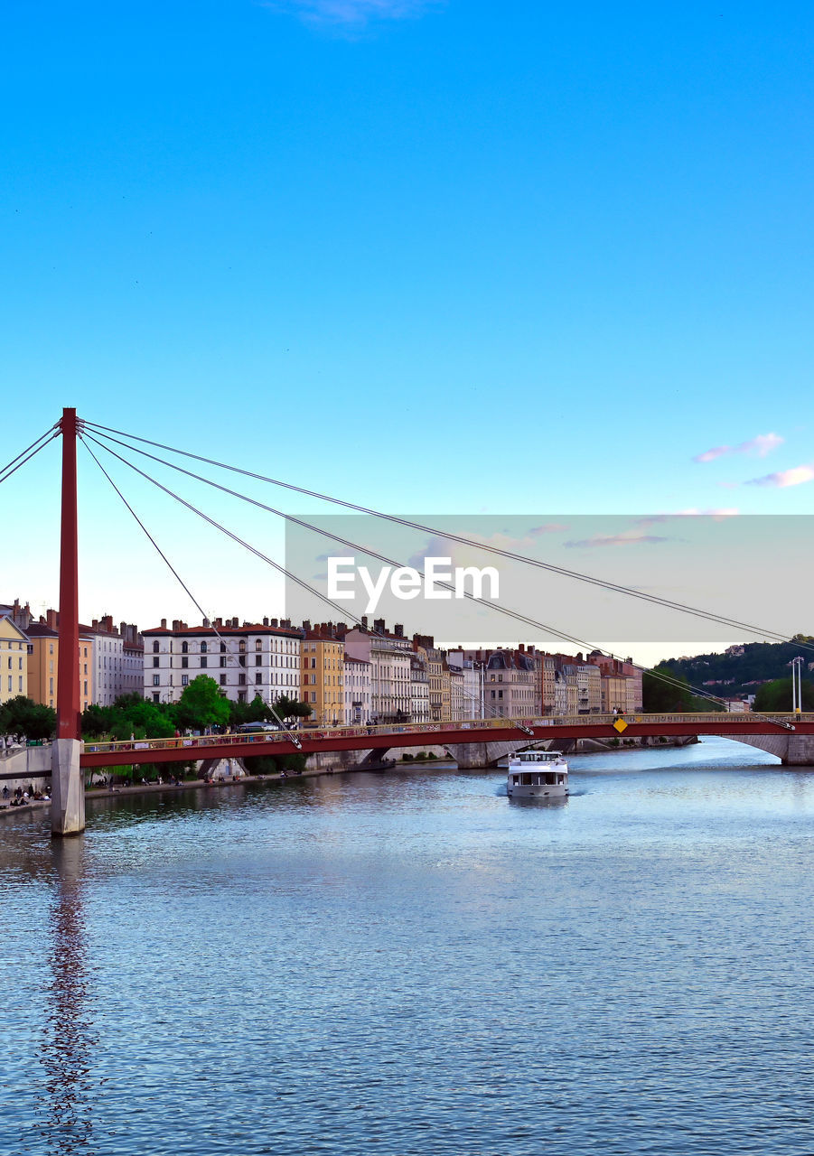 VIEW OF BRIDGE OVER RIVER AGAINST CLEAR BLUE SKY