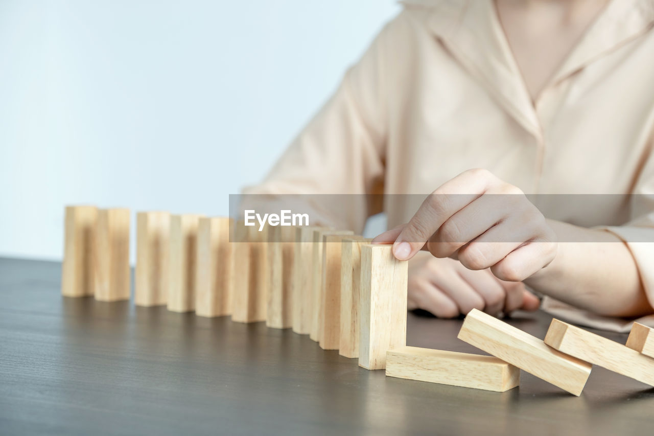 BOY PLAYING WITH TOY ON WOODEN TABLE