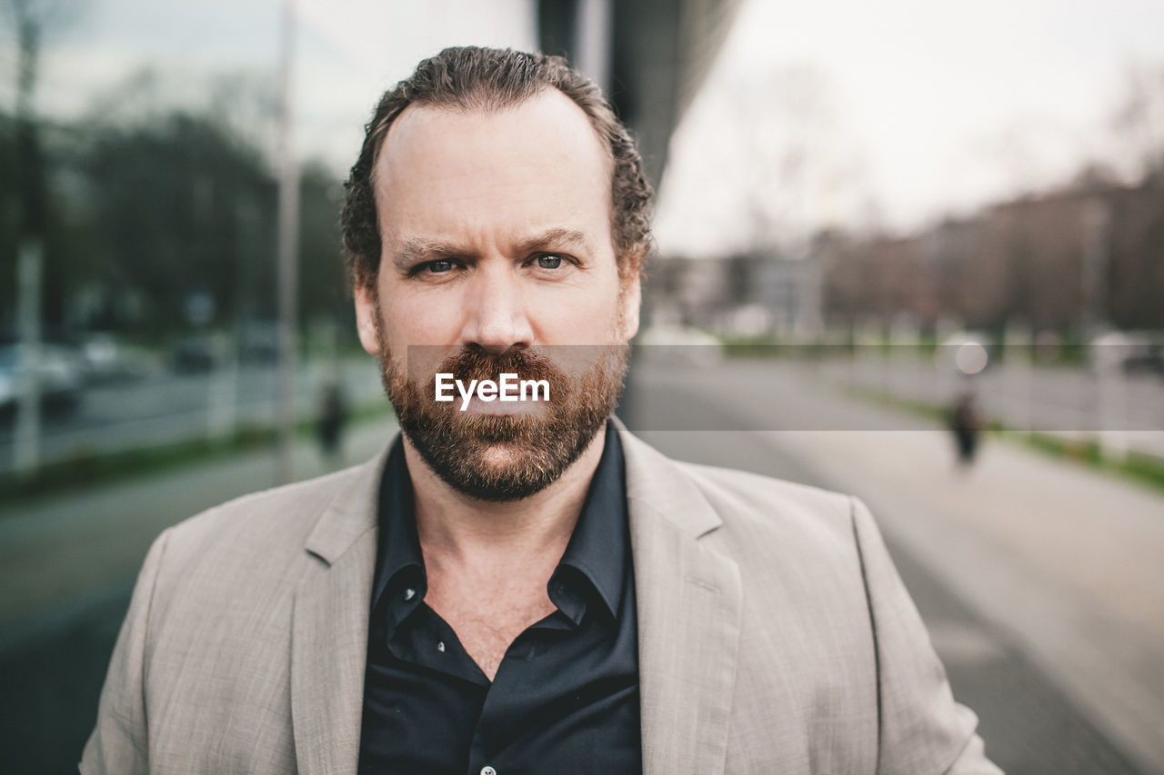 Portrait of businessman standing outdoors