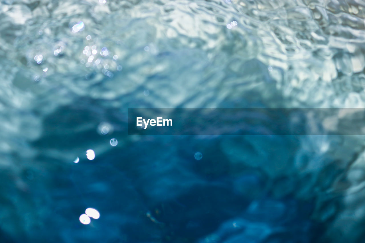 CLOSE-UP OF BUBBLES OVER SWIMMING POOL