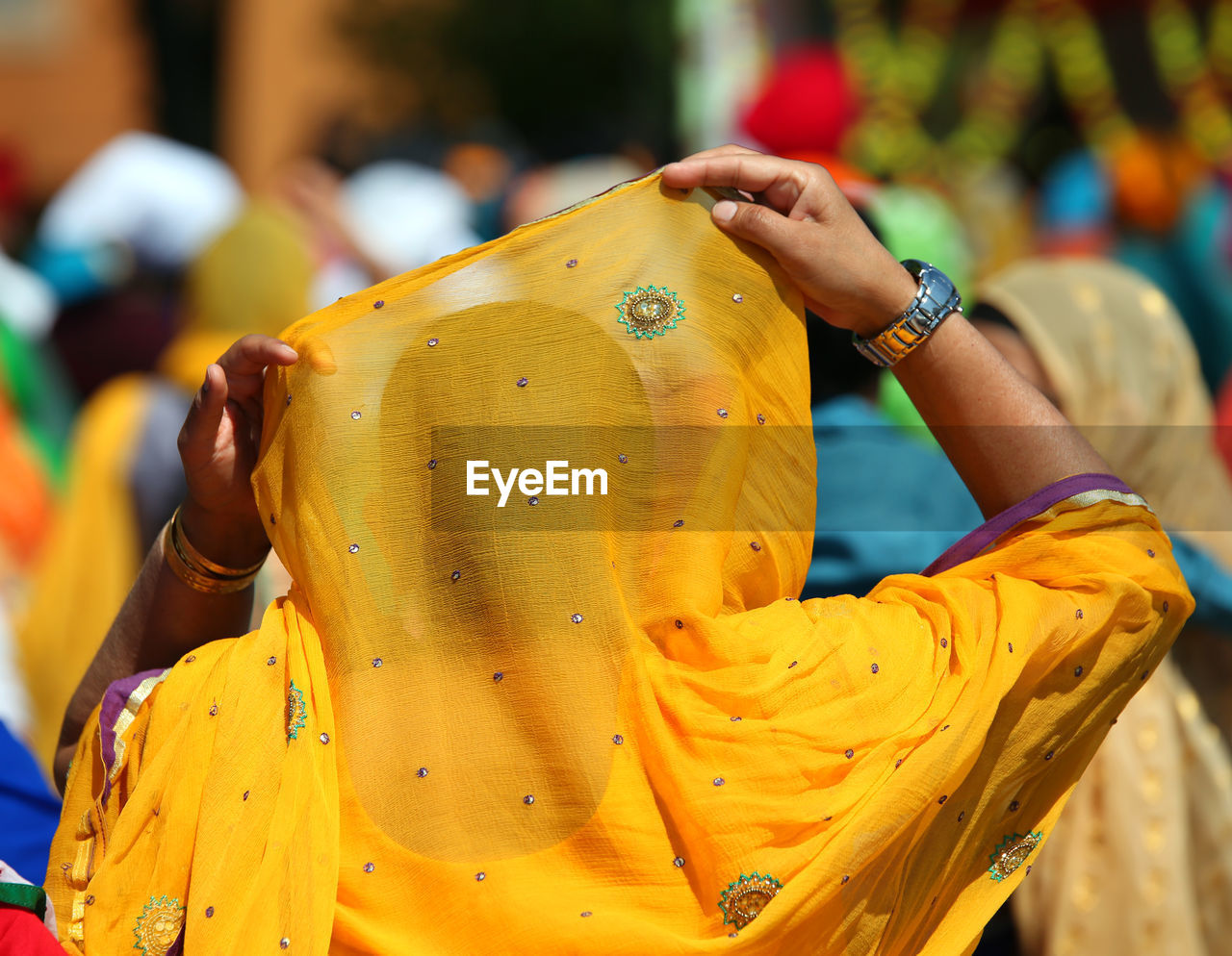 Woman with yellow veil during a religious parade