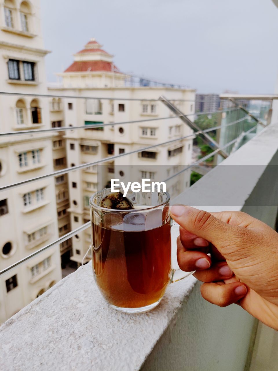 Cropped hand of woman holding drink