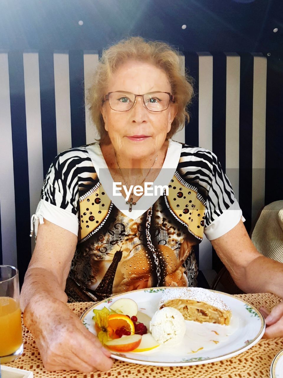 Portrait of senior woman having food in restaurant