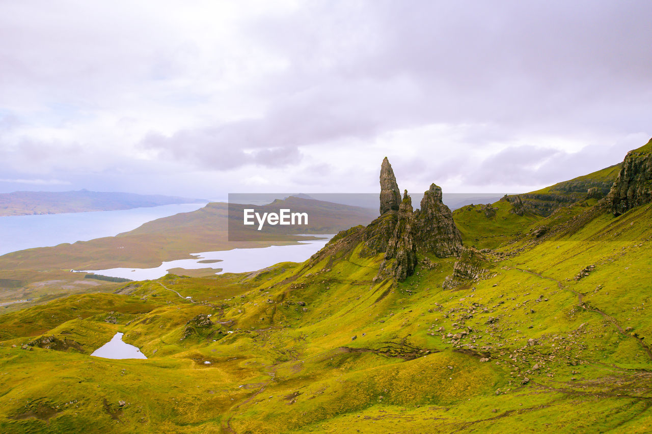 environment, landscape, hill, scenics - nature, nature, sky, land, cloud, beauty in nature, mountain range, highland, travel destinations, travel, water, meadow, no people, tourism, plateau, wilderness, tranquility, non-urban scene, grassland, building, architecture, grass, plant, tranquil scene, rural area, sea, green, ridge, social issues, overcast, outdoors, rural scene, environmental conservation, trip, vacation, idyllic, built structure, holiday, dramatic sky, beach, summer, history, day, building exterior, fog, rock, activity, religion, the past