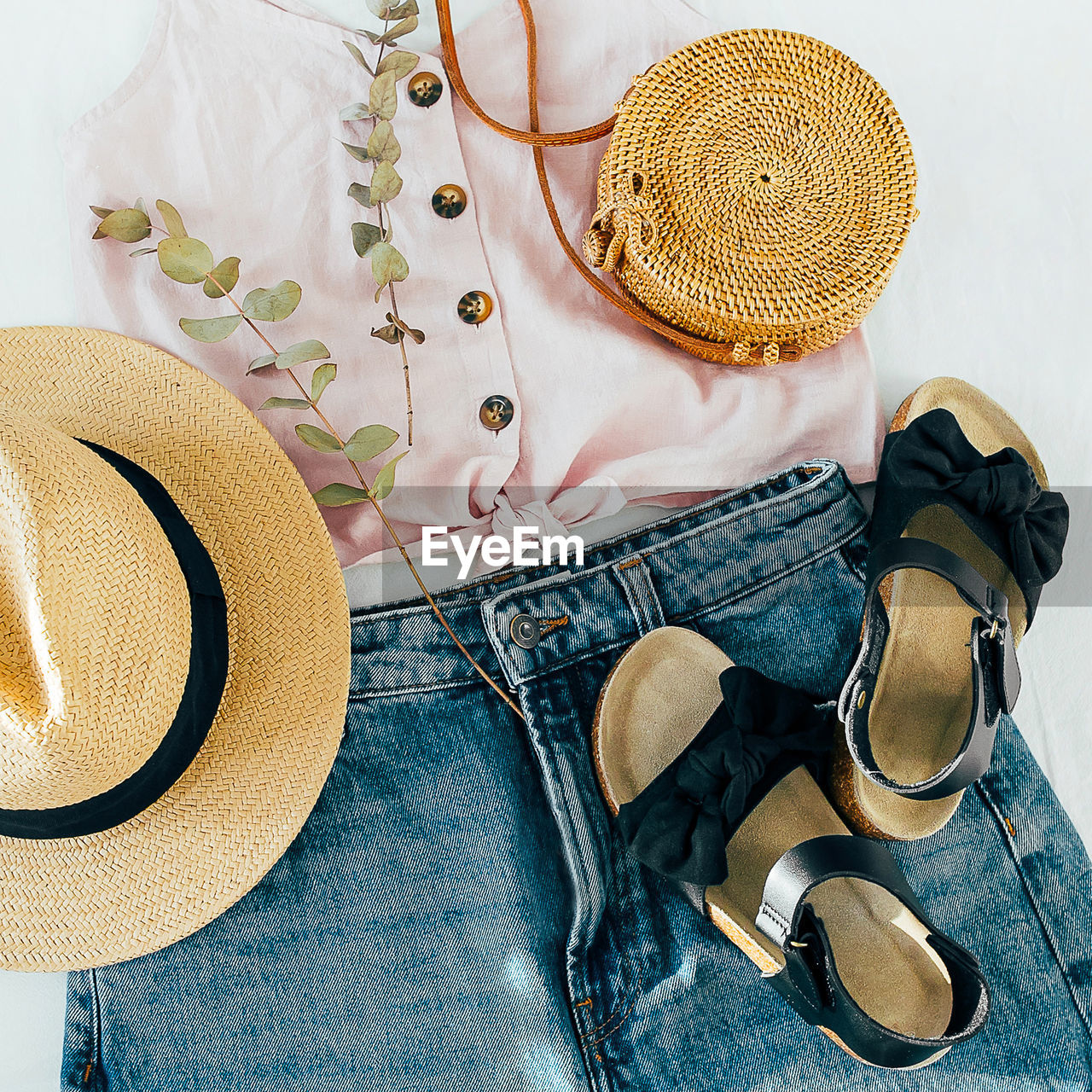 Women's fashion summer clothes. stylish female straw hat, denim short, top, black sandals.