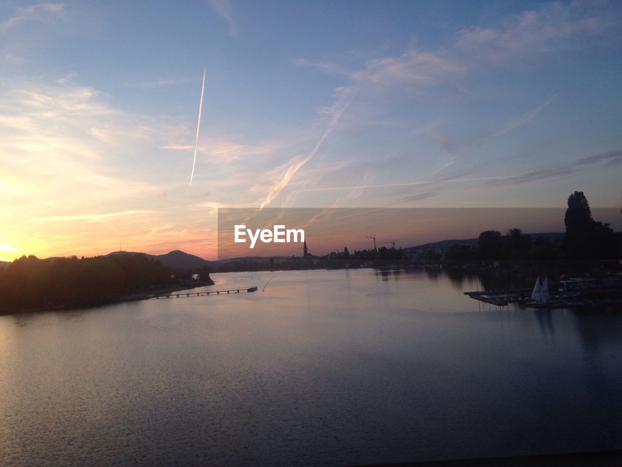 SCENIC VIEW OF DRAMATIC SKY OVER RIVER