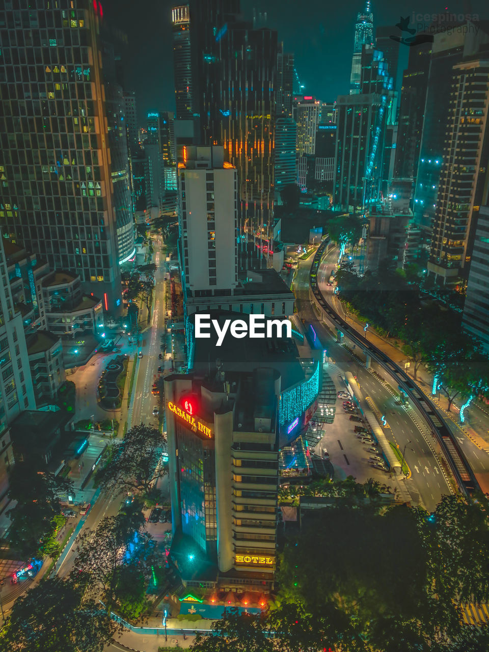 High angle view of illuminated street amidst buildings at night