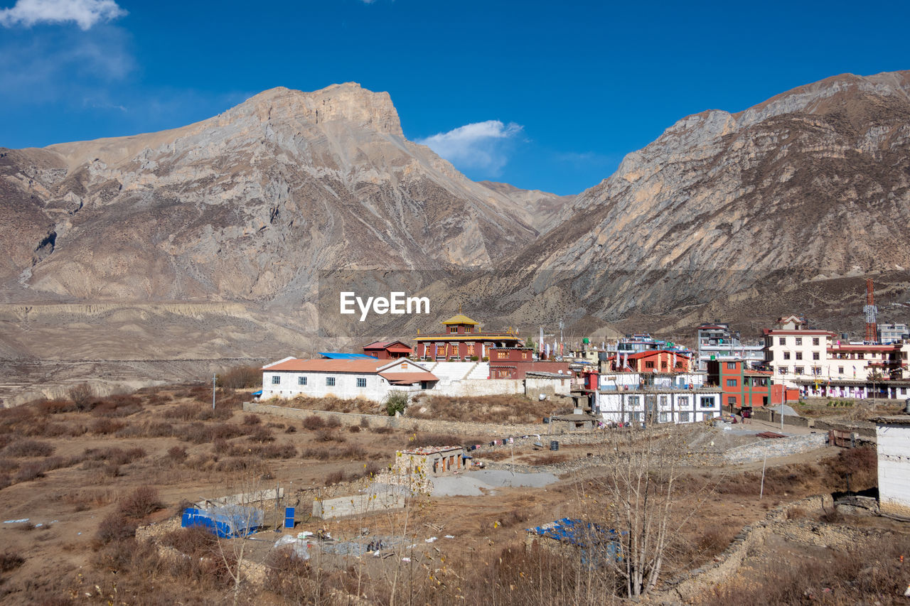 Houses and mountains against sky