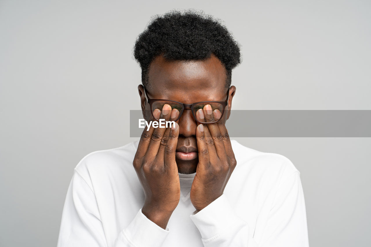 Portrait of young man against white background