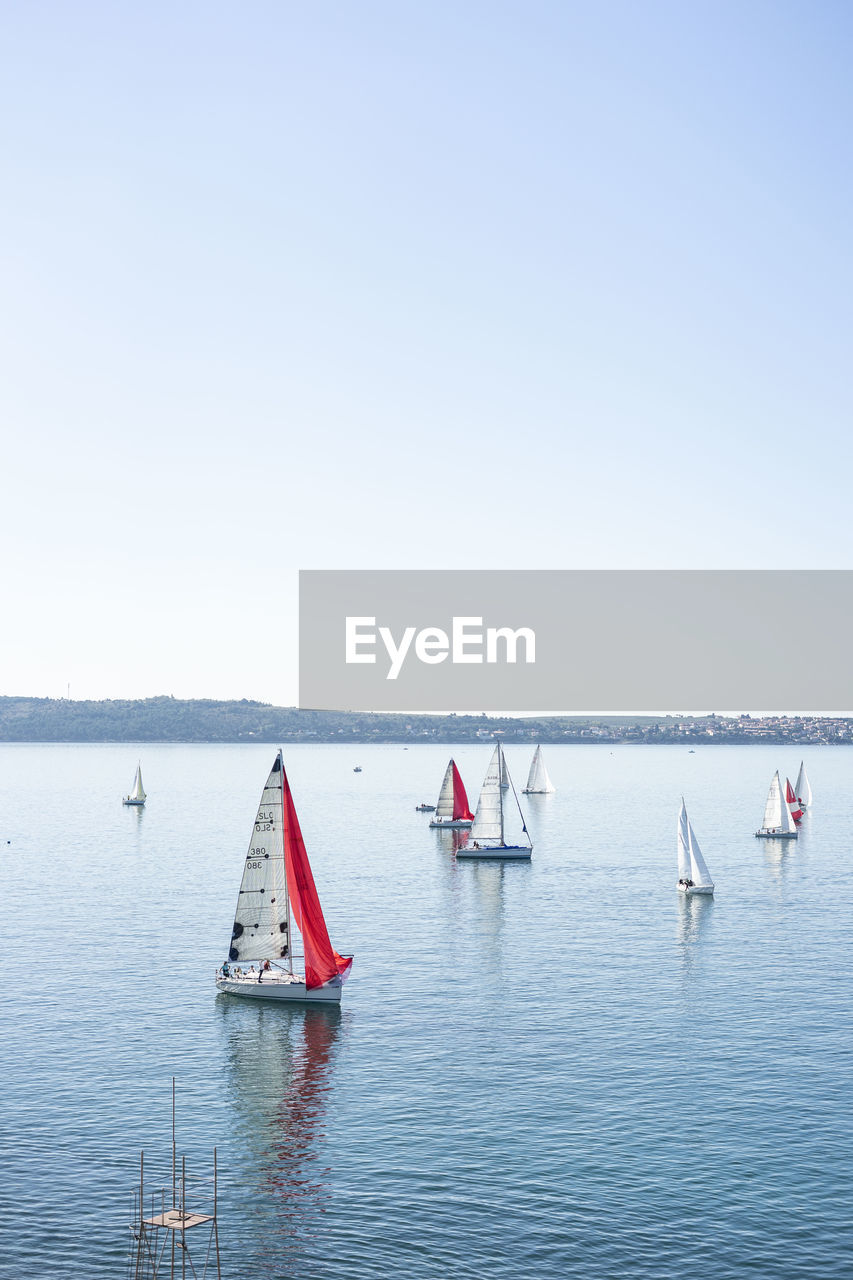 VIEW OF SAILBOAT IN SEA AGAINST CLEAR SKY