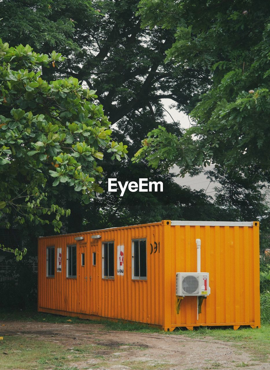 Built structure on field against trees and plants