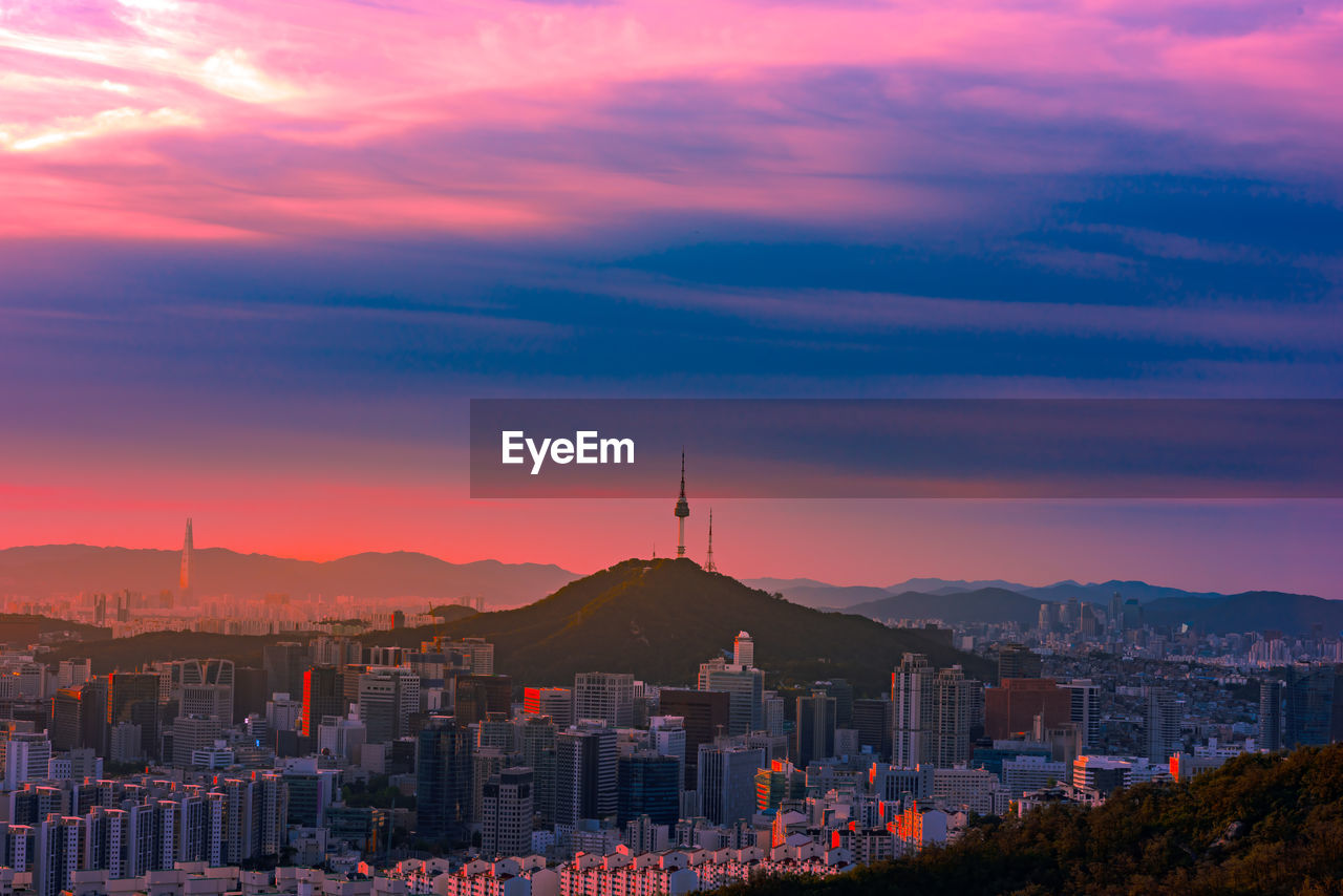 High angle view of buildings against sky at sunset