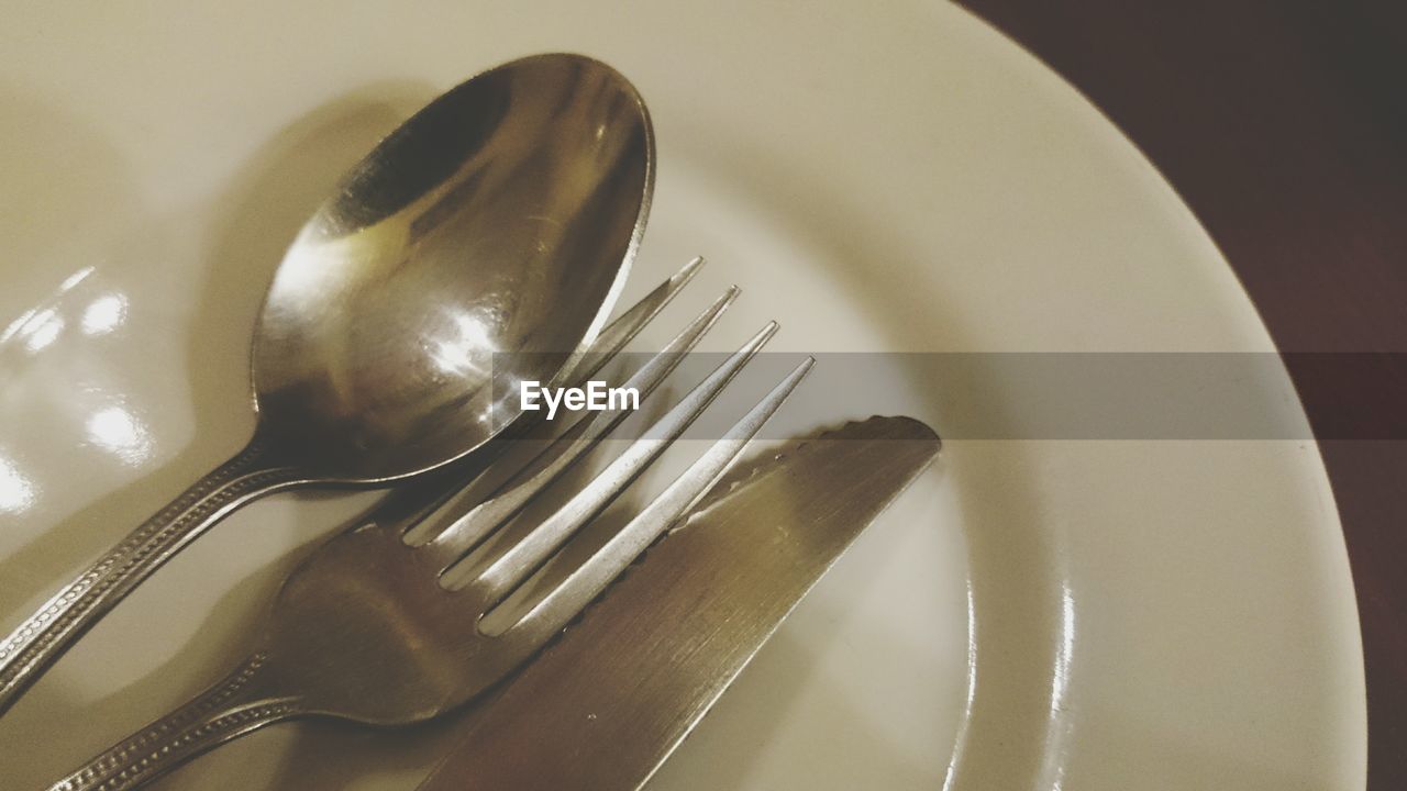 Close-up of silverware on plate