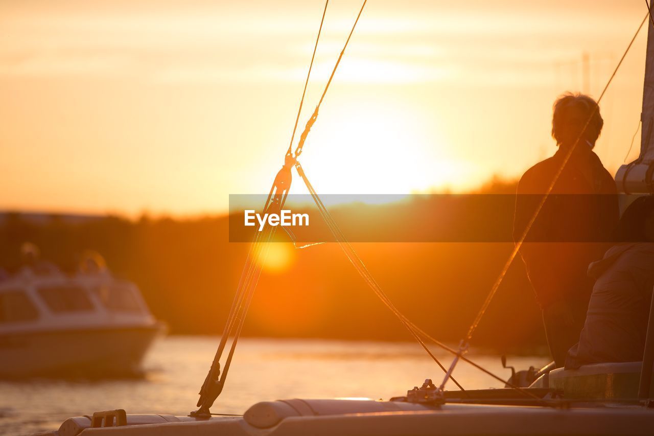 Scenic view of sailboats at sunset