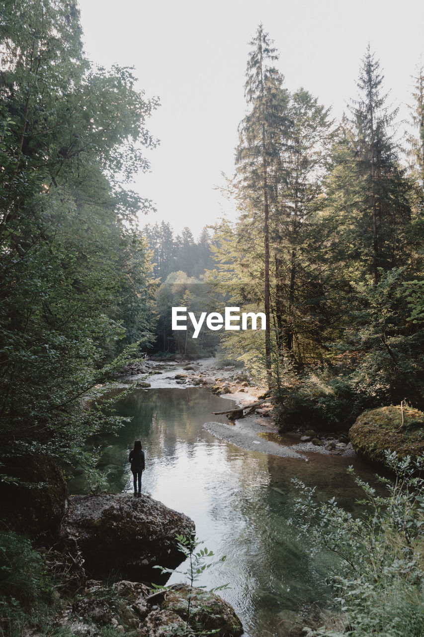 FULL LENGTH OF WOMAN STANDING ON ROCKS