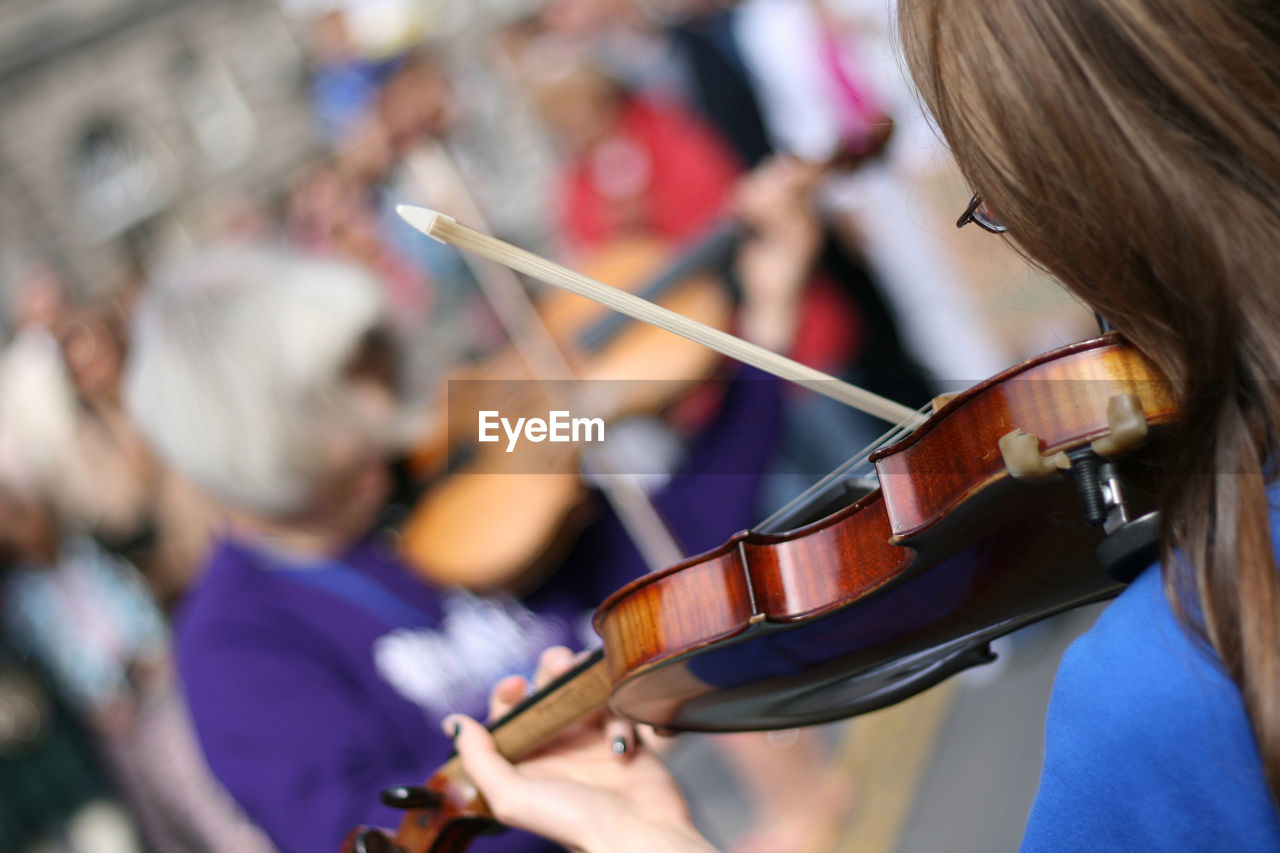 Tilt shot of woman playing violin