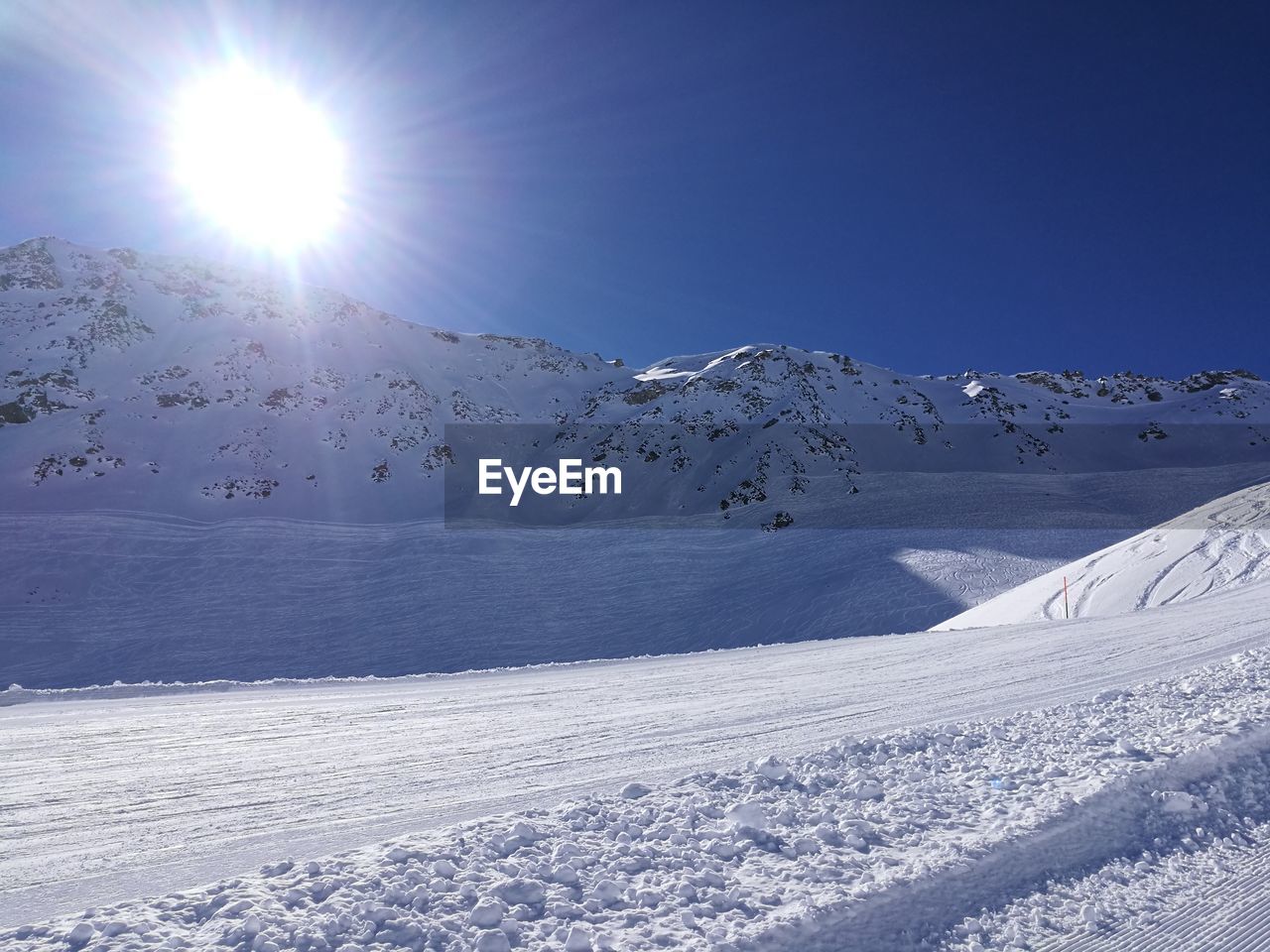 Scenic view of snow covered mountains against sky