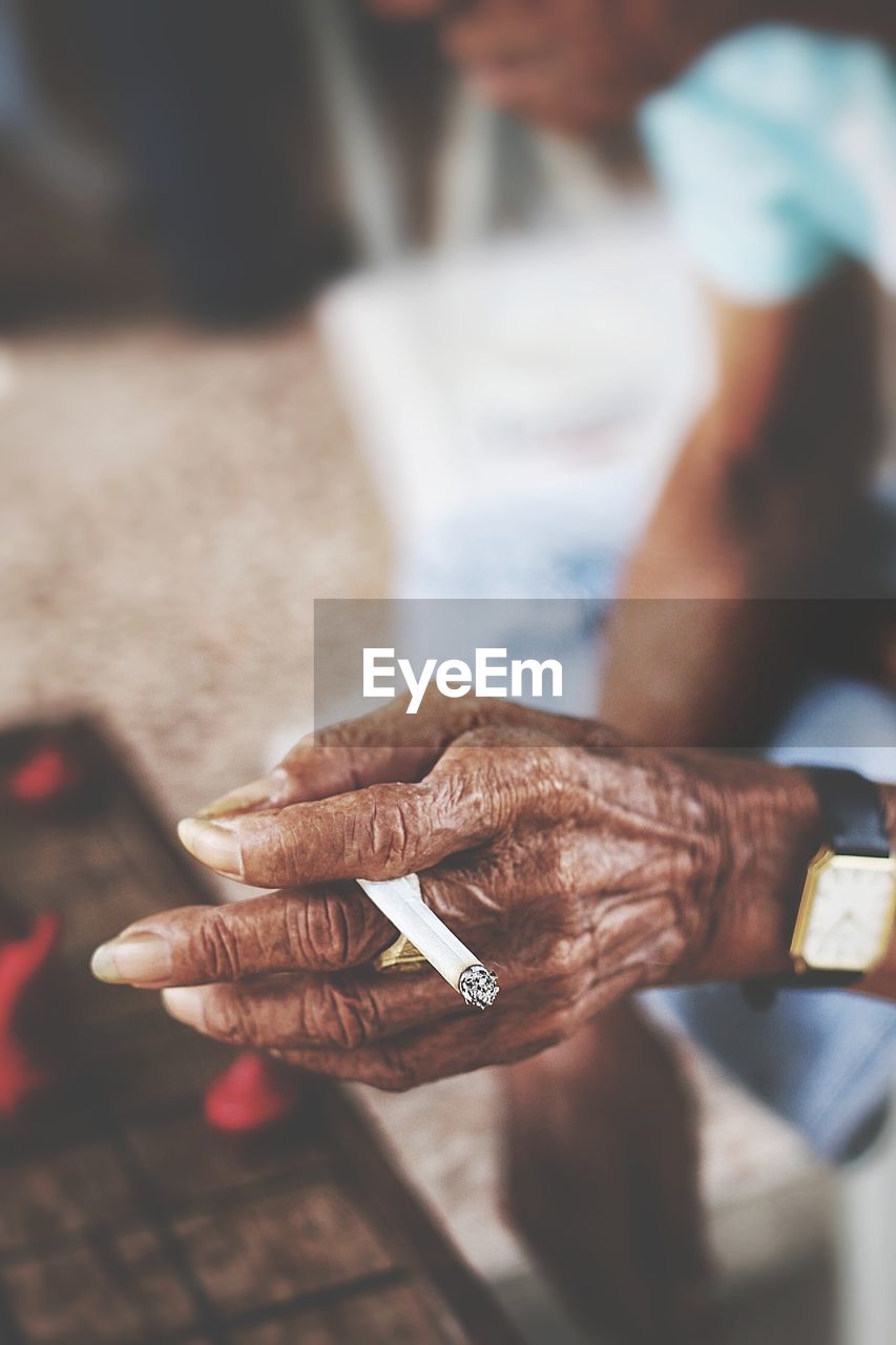 CLOSE-UP OF WOMAN HAND HOLDING CAMERA