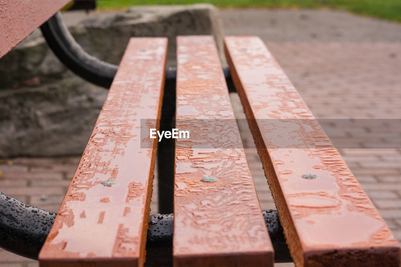 HIGH ANGLE VIEW OF RUSTY METALLIC BENCH