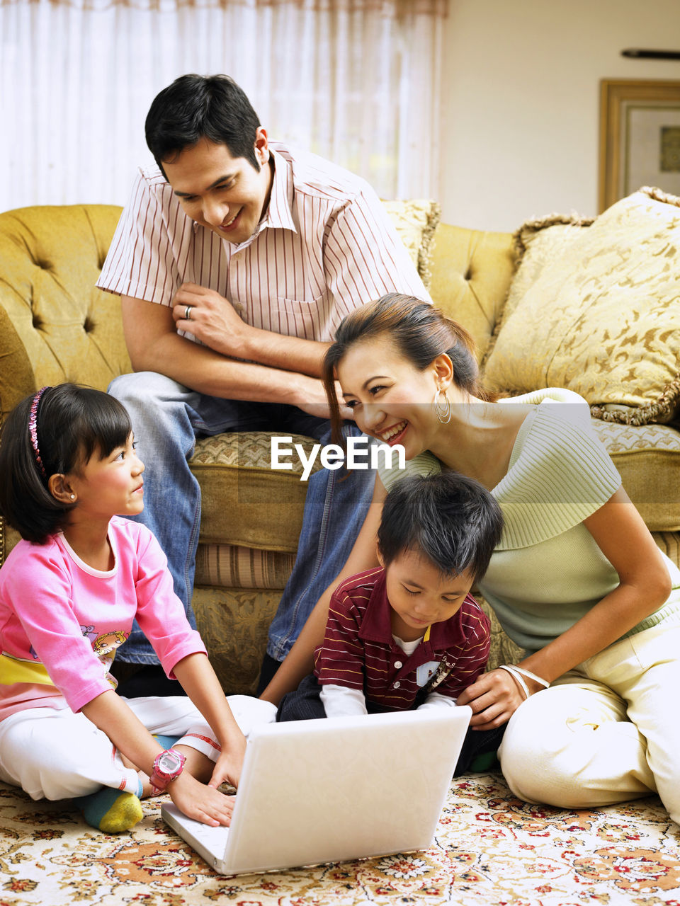 Family using laptop at home