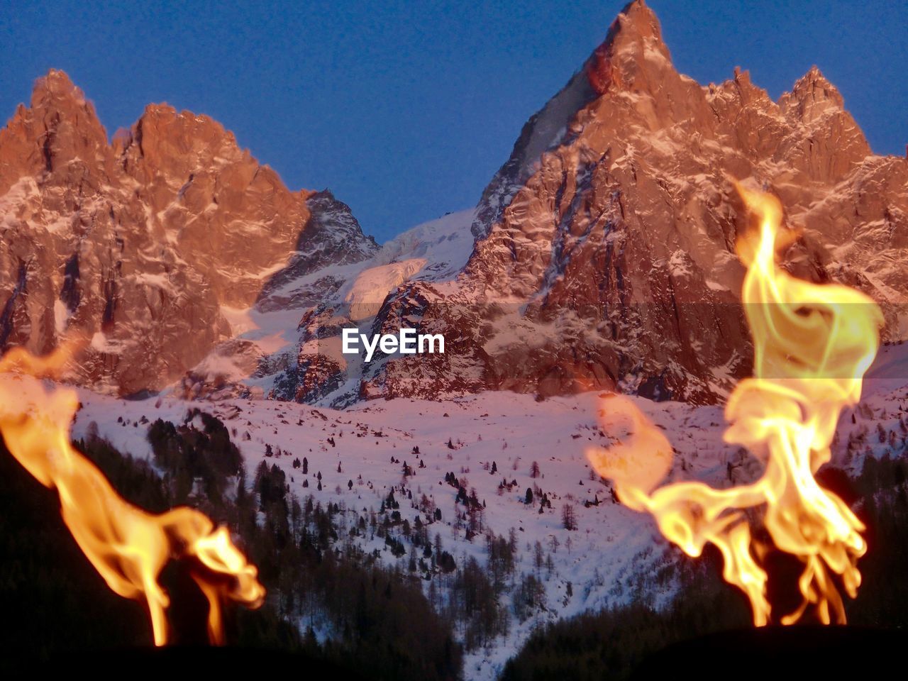 Bonfire on rocky mountain during winter
