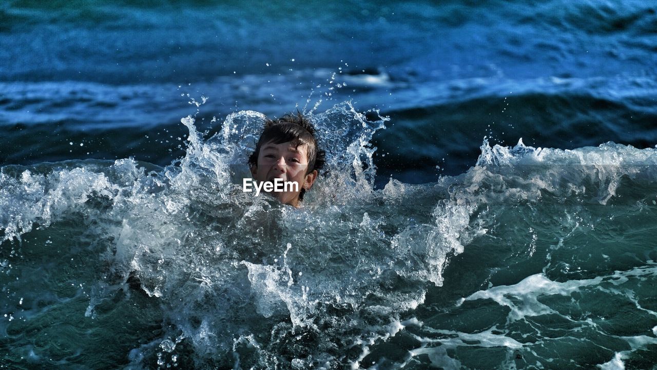 High angle portrait of boy swimming in sea