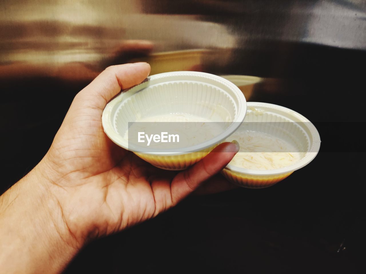 Close-up of hand holding coffee cup