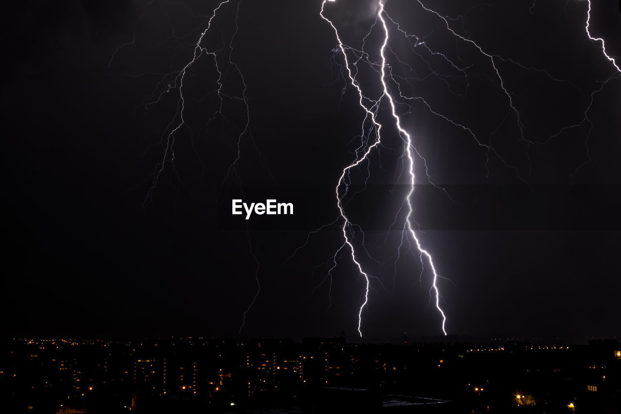 Lighting storm over city at night