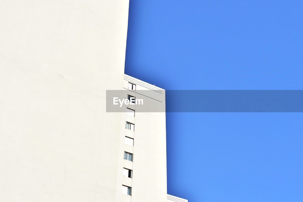 LOW ANGLE VIEW OF BUILT STRUCTURE AGAINST BLUE SKY