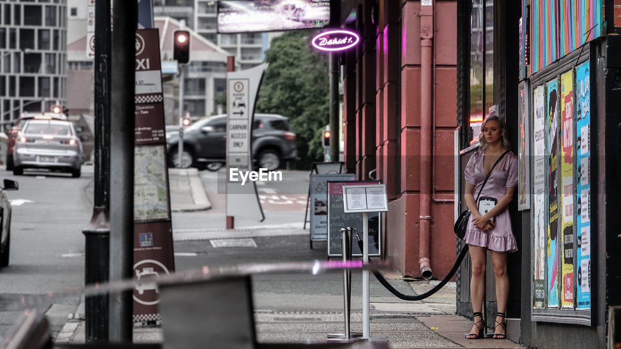 WOMAN STANDING ON STREET