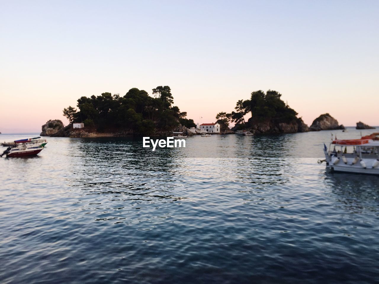 Scenic view of lake against clear sky during sunset