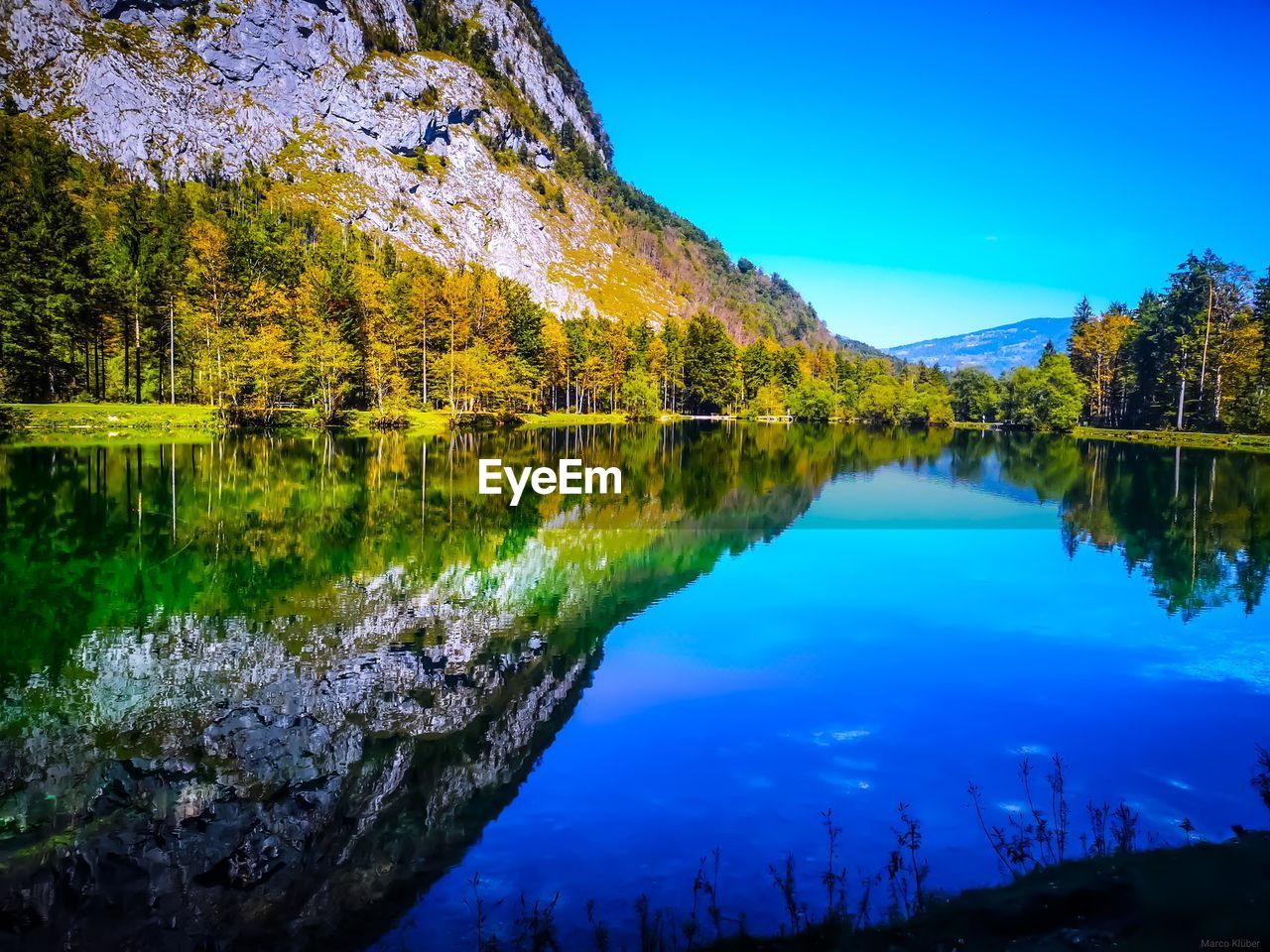 Scenic view of lake against blue sky