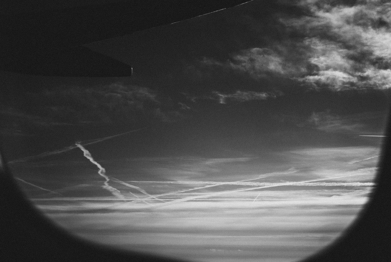 Cloudy sky seen through airplane glass window