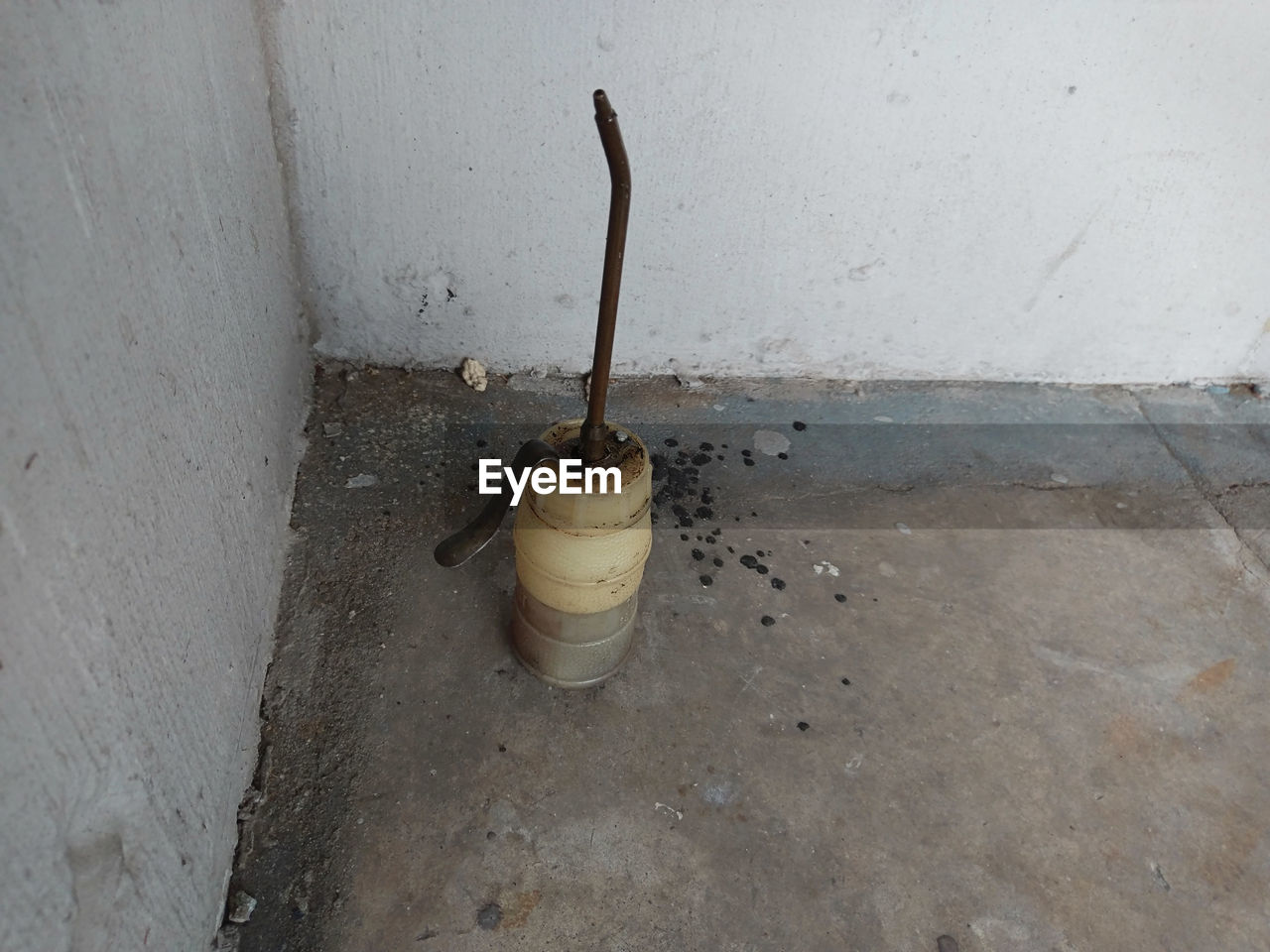 oil can in the corner at public sidewalk City EyeEmNewHere Trash Wall Architecture Close-up Concrete Garbage High Angle View No People Object Oil Can Old Single Object Still Life Street Street Photography Urban Wall - Building Feature Waste