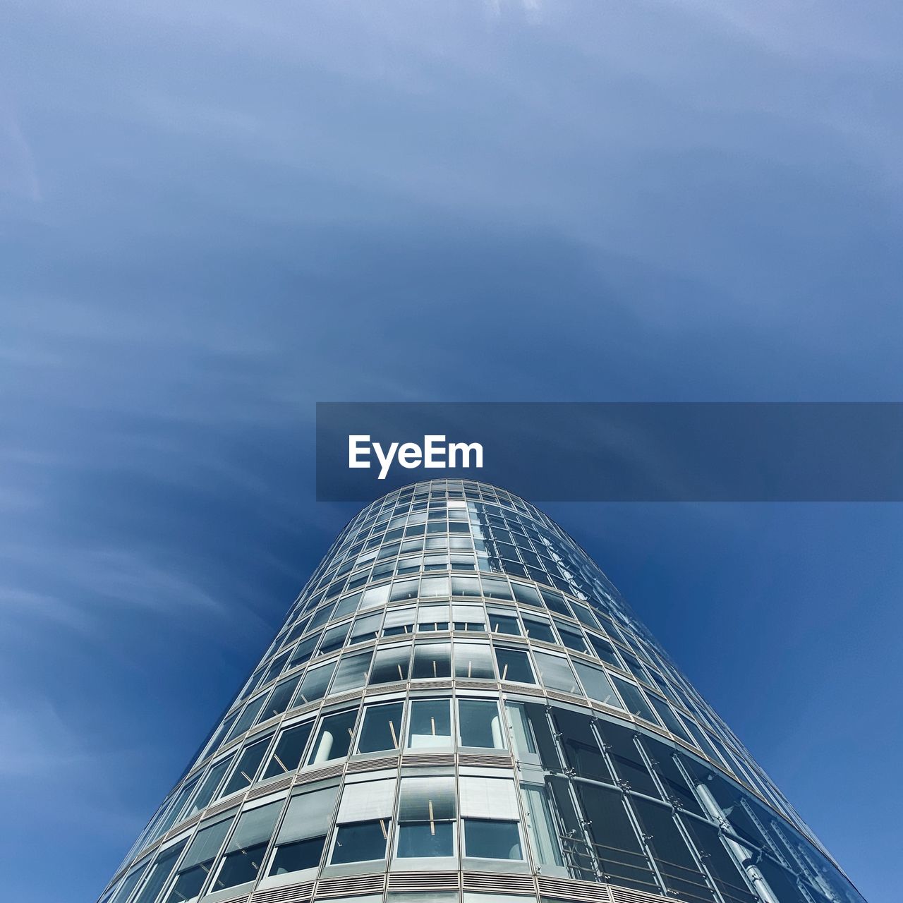 Low angle view of modern building against blue sky