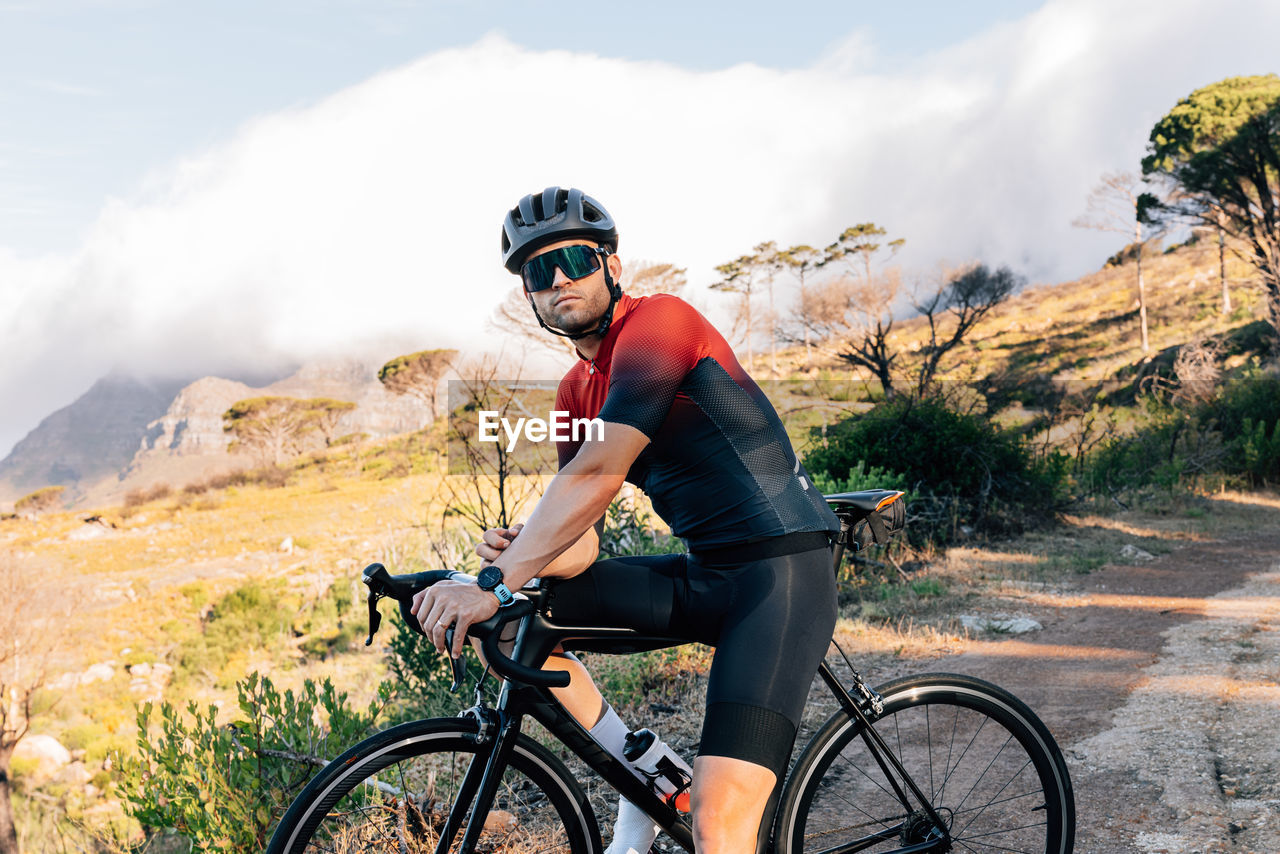 side view of man riding bicycle on mountain