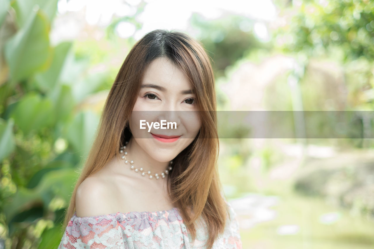 Portrait of smiling young woman in park