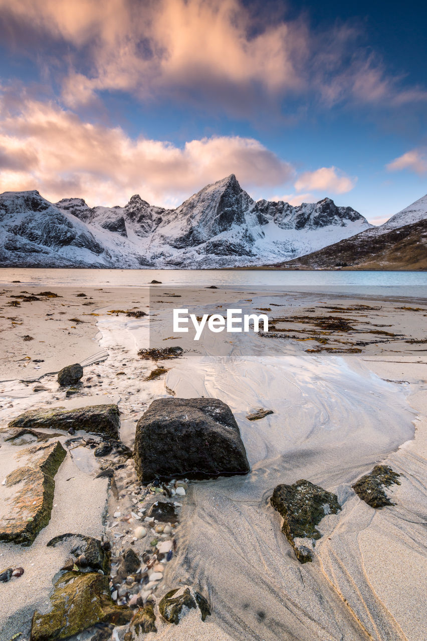 Scenic view of beach against sky during winter