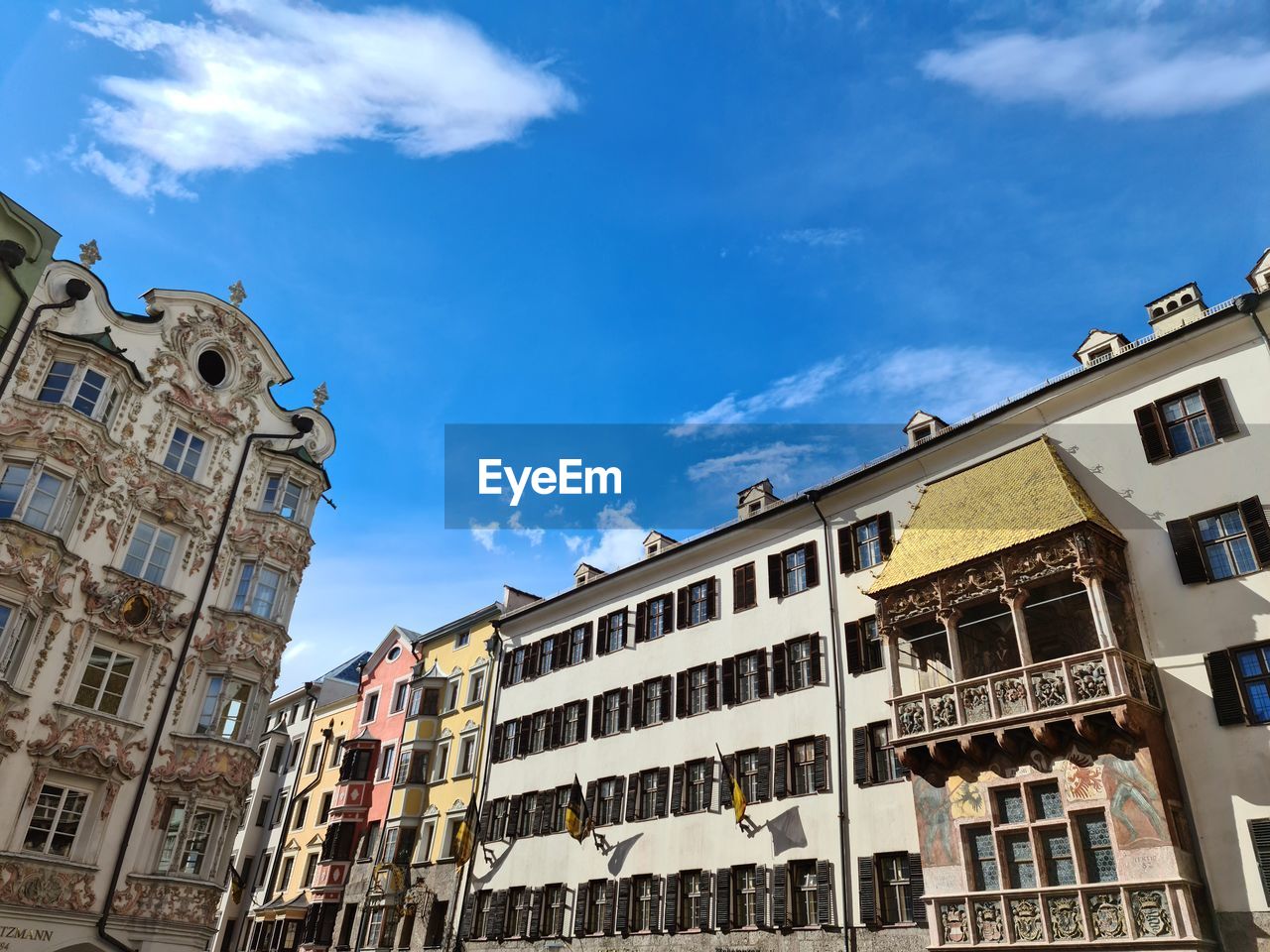 Low angle view of buildings against cloudy sky